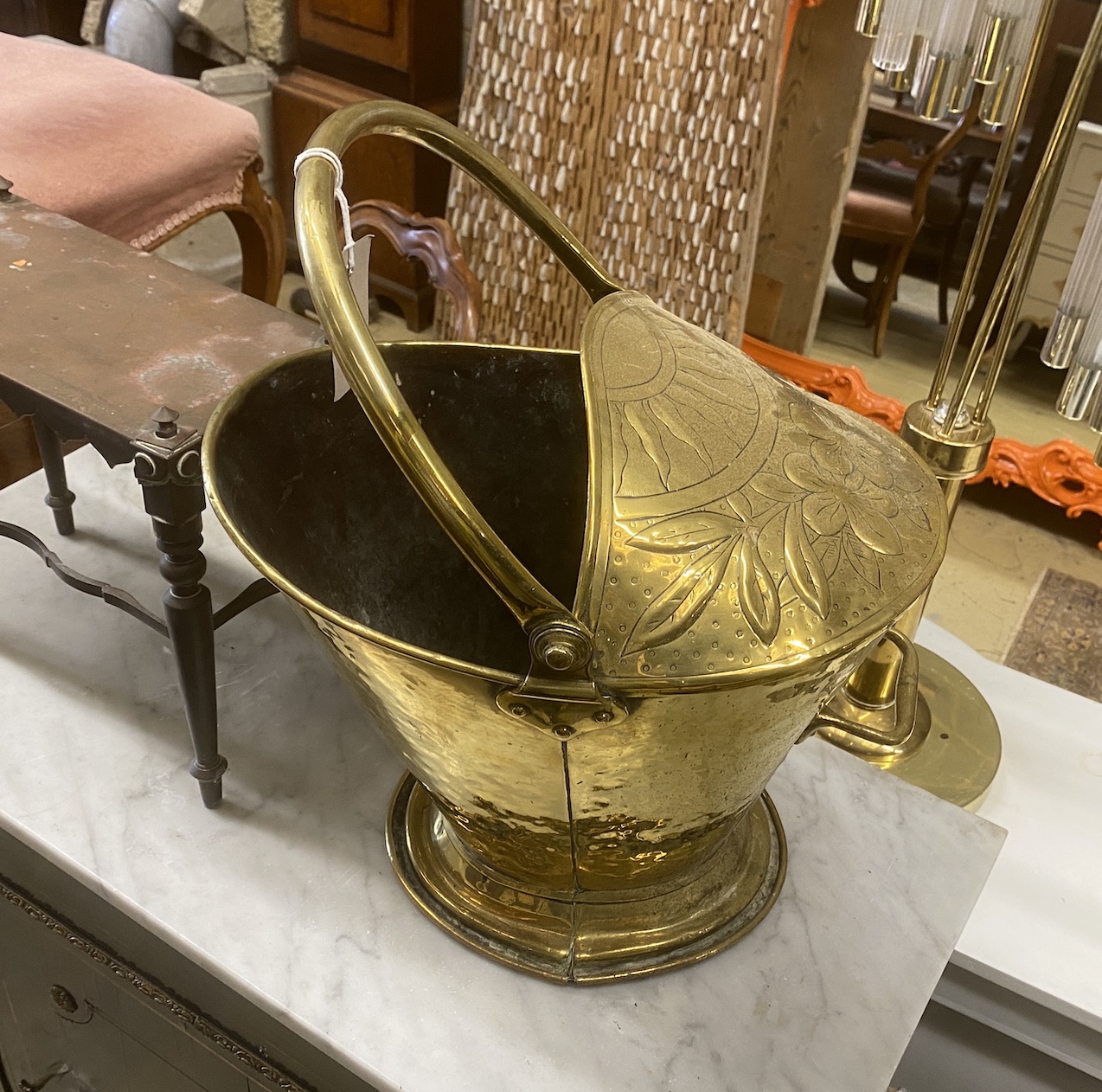 A 19th century Dutch embossed brass coal scuttle with swing handle together with a Victorian copper trivet